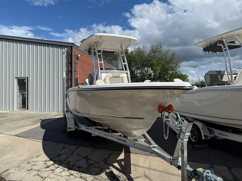 Slide: The Image of 2025 Key West 219 FS boat on trailer, parked outdoors near a building. - 3
