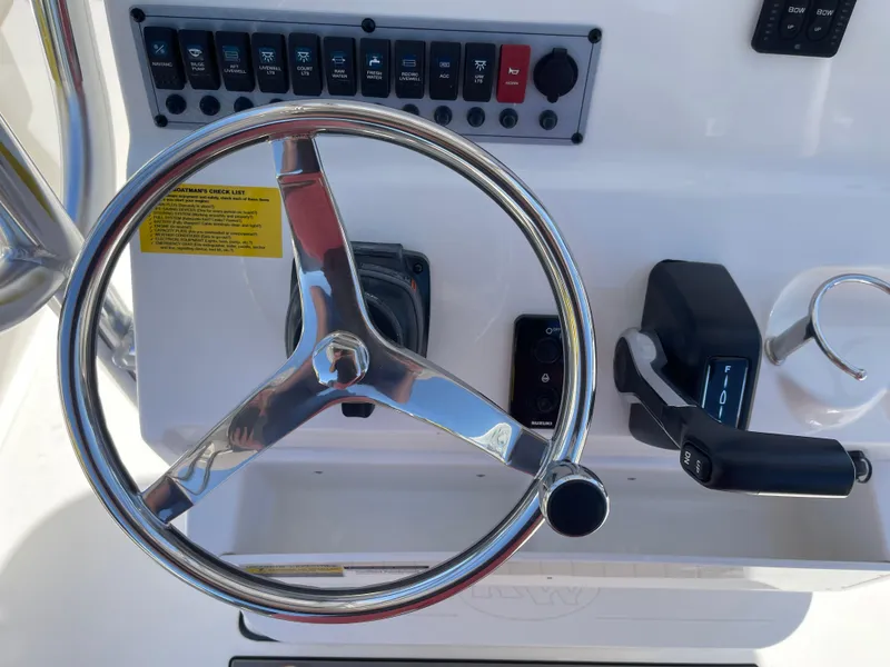 Slide: The Image of Steering wheel and controls of 2025 Key West 219 FS boat. - 7