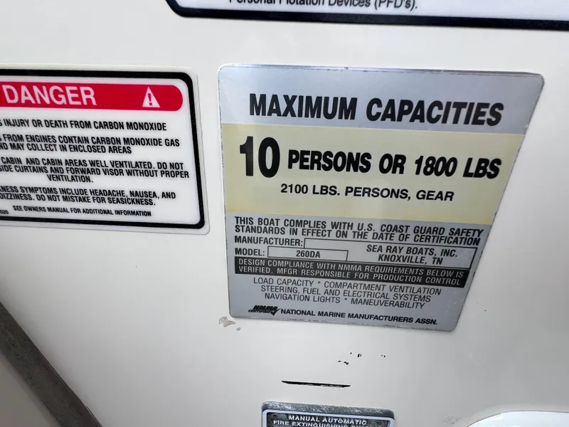 Slide: The Image of ```json
{
"alt_text": "Capacity label for 2004 Sea Ray 260 Sundancer, max 10 persons or 1800 lbs."
}
``` - 18