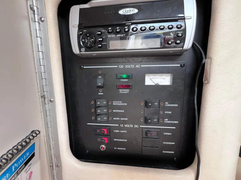 Slide: The Image of Control panel and stereo system on a 2004 Sea Ray 260 Sundancer boat. - 25