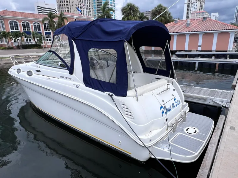 Slide: The Image of 2004 Sea Ray 260 Sundancer boat docked at marina with blue canopy. - 3