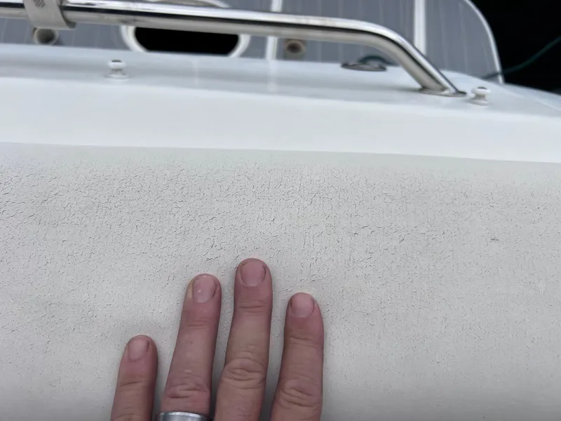 Slide: The Image of Hand touching the deck of a 2004 Sea Ray 260 Sundancer boat. - 30