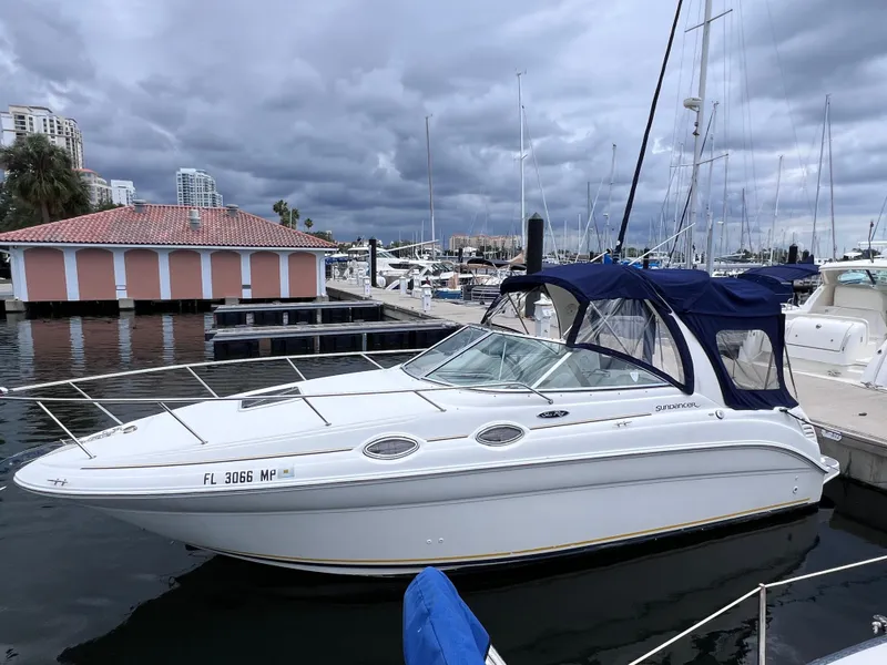 Slide: The Image of 2004 Sea Ray 260 Sundancer docked at marina under cloudy skies. - 4