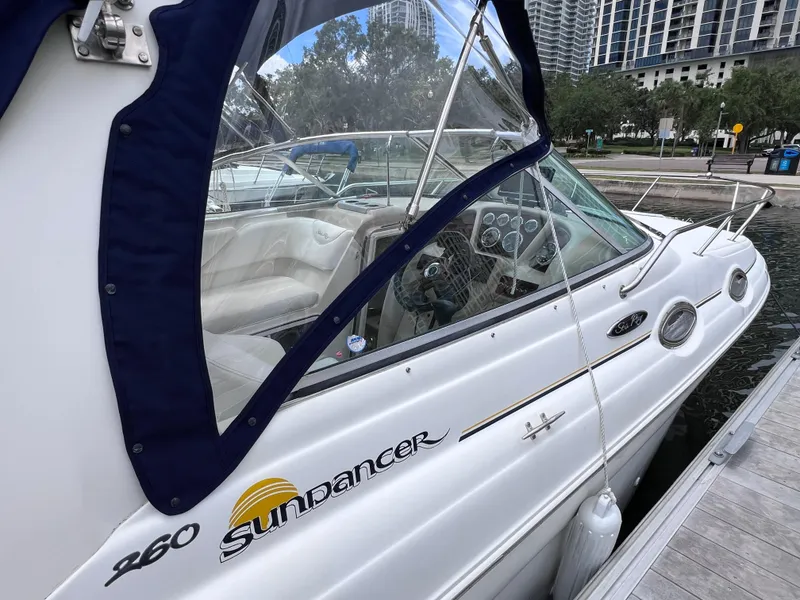 Slide: The Image of 2004 Sea Ray 260 Sundancer docked, featuring sleek design and spacious interior. - 7