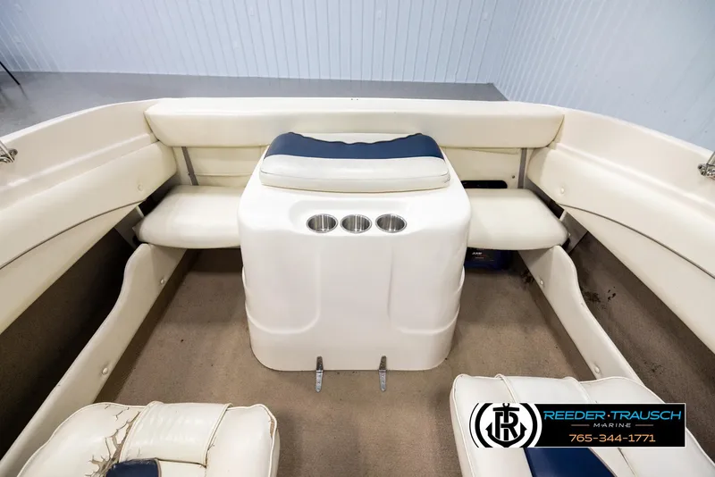 Slide: The Image of Interior of a 2002 Rinker 180 boat with seating and cup holders. - 18