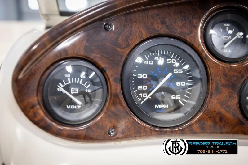Slide: The Image of Dashboard of a 2002 Rinker 180 boat with speedometer and voltmeter gauges. - 25