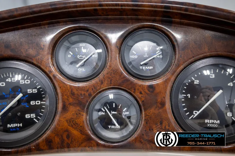Slide: The Image of Dashboard of a 2002 Rinker 180 boat with gauges for oil, temperature, speed, and RPM. - 26