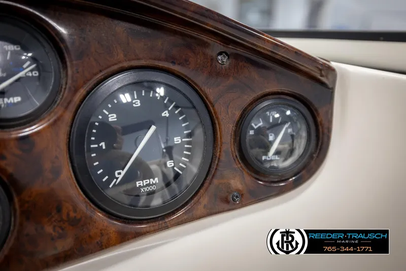 Slide: The Image of Dashboard of a 2002 Rinker 180 boat with RPM and fuel gauges. - 27