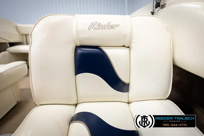 Slide: The Image of 2002 Rinker 180 boat seat with white and blue upholstery, Reeder-Trausch Marine logo. - 34