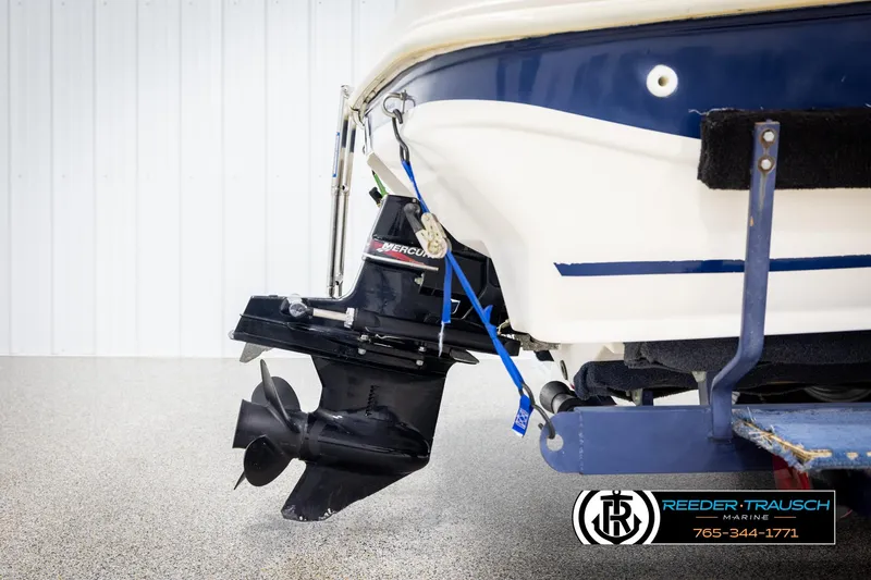 Slide: The Image of 2002 Rinker 180 boat stern with Mercury outboard motor on trailer. - 38