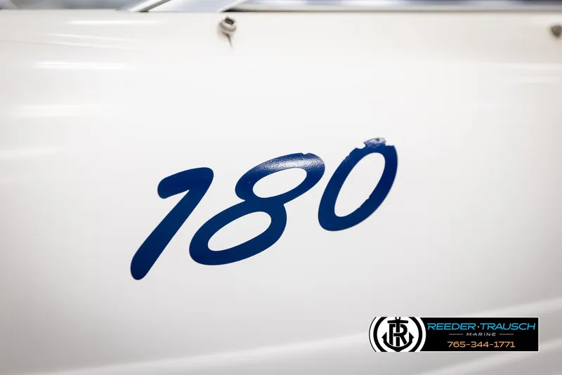 Slide: The Image of Close-up of blue '180' on 2002 Rinker boat, white background. - 41