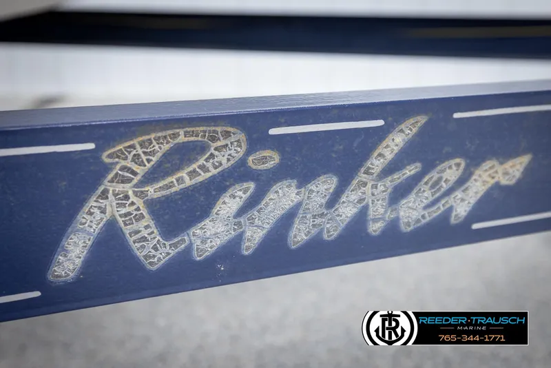 Slide: The Image of Close-up of 2002 Rinker 180 boat logo with textured lettering. - 43