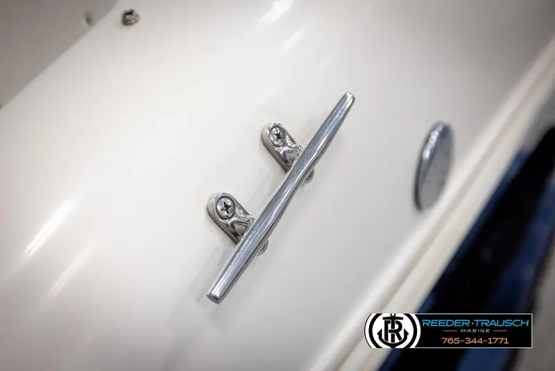Slide: The Image of 2002 Rinker 180 boat cleat detail with Reeder Trausch Marine logo. - 44