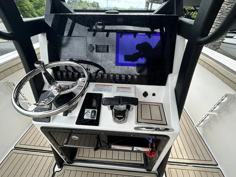 Slide: The Image of 2023 Yamaha Boats 255 FSH Sport E dashboard with steering wheel and controls. - 5