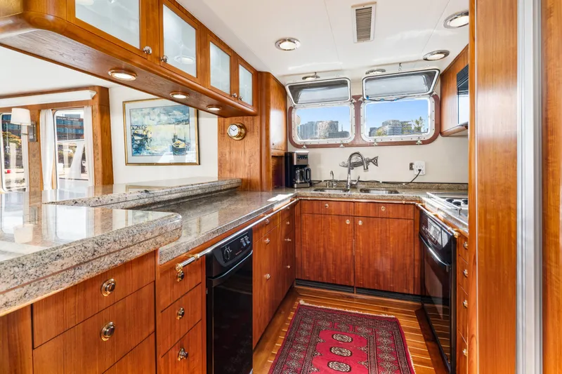 Slide: The Image of Luxurious 1998 Northern Marine Trawler kitchen with wood cabinetry and granite countertops. - 14