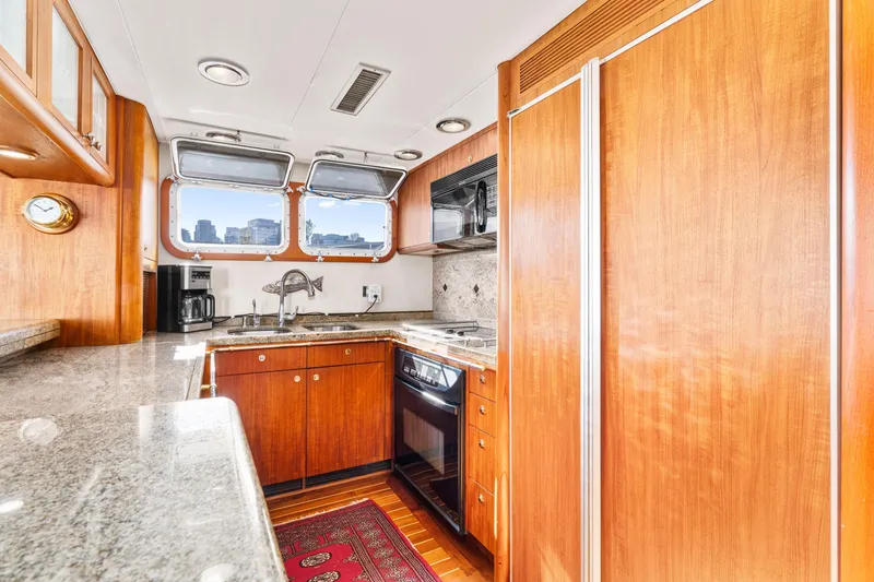 Slide: The Image of Luxurious 1998 Northern Marine Trawler kitchen with wood cabinetry and granite countertops. - 15