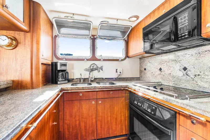 Slide: The Image of Luxurious 1998 Northern Marine Trawler kitchen with wood cabinetry and modern appliances. - 16