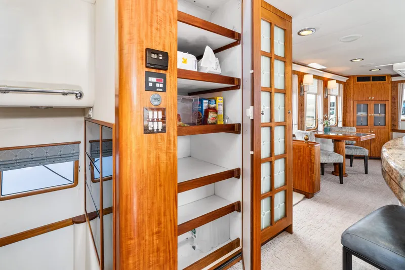 Slide: The Image of Interior of 1998 Northern Marine Trawler with wooden cabinetry and dining area. - 18
