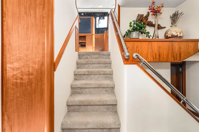 Slide: The Image of Interior of 1998 Northern Marine Trawler with carpeted stairs and wooden accents. - 19