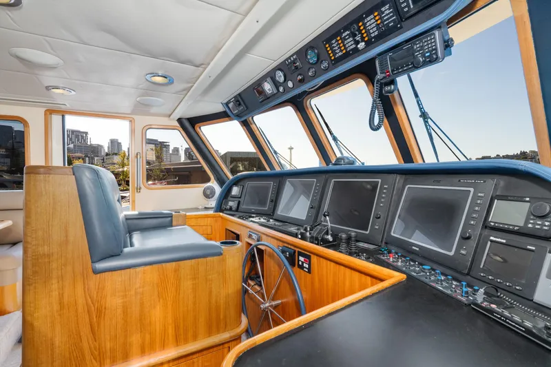 Slide: The Image of 1998 Northern Marine Trawler helm with navigation equipment and city skyline view. - 22