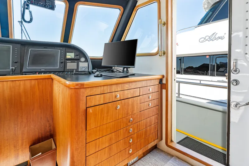 Slide: The Image of 1998 Northern Marine Trawler helm with wooden cabinetry and navigation equipment. - 23