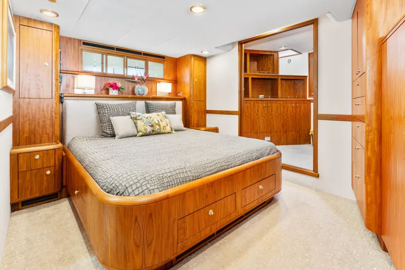 Slide: The Image of Luxurious 1998 Northern Marine Trawler bedroom with elegant wood finishes and cozy bedding. - 28