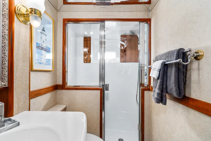Slide: The Image of Luxurious bathroom in 1998 Northern Marine Trawler with shower, towels, and nautical decor. - 33