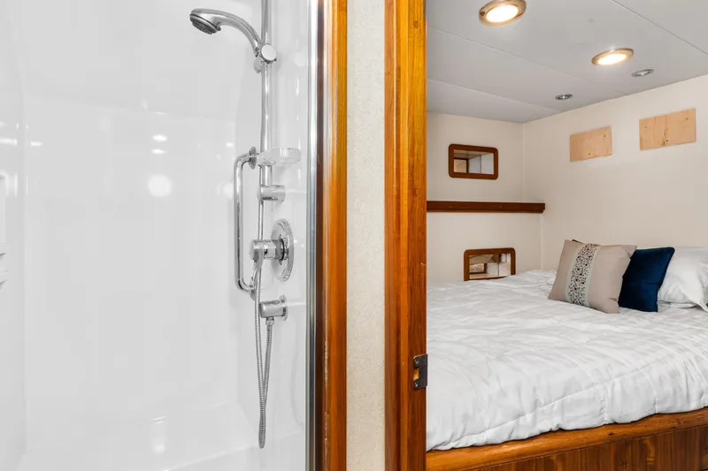 Slide: The Image of 1998 Northern Marine Trawler interior with cozy bedroom and modern shower. - 36