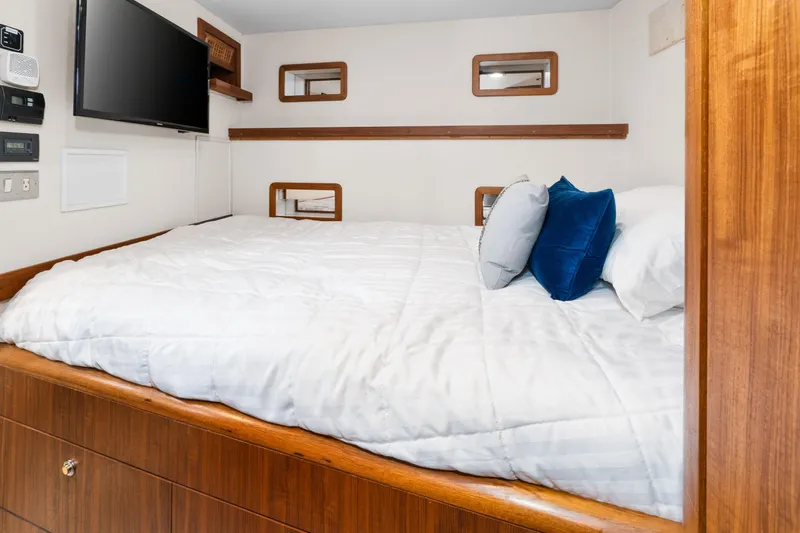 Slide: The Image of Cozy bedroom interior of 1998 Northern Marine Trawler with TV and plush bedding. - 38