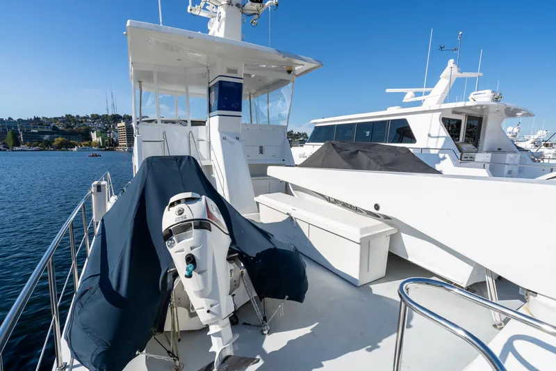 Slide: The Image of 1998 Northern Marine Trawler on water, featuring deck and outboard motor, under clear blue sky. - 41