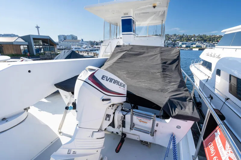 Slide: The Image of 1998 Northern Marine Trawler with Evinrude motor, docked at marina under clear blue sky. - 43