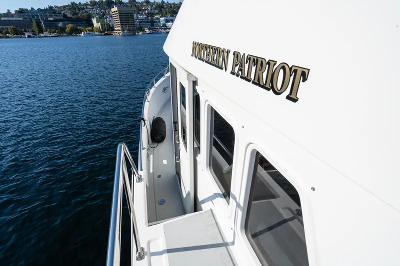 Slide: The Image of 1998 Northern Marine Trawler "Northern Patriot" on calm water, cityscape in background. - 45
