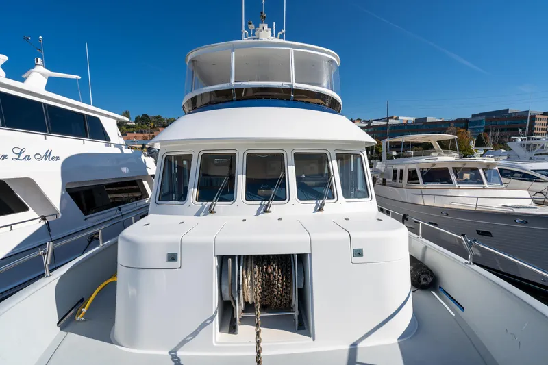 Slide: The Image of 1998 Northern Marine Trawler docked at marina, showcasing front view and windows. - 56