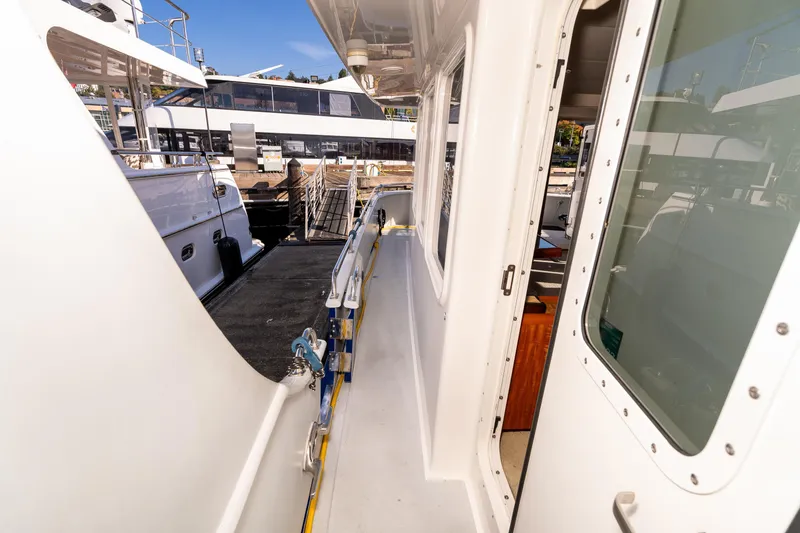 Slide: The Image of 1998 Northern Marine Trawler deck view with docked boats in the background. - 60