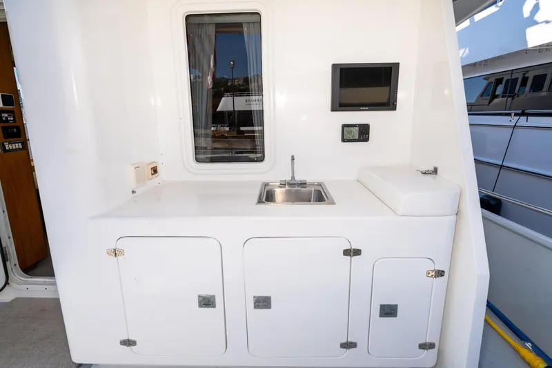 Slide: The Image of 1998 Northern Marine Trawler outdoor sink area with storage and control panel. - 61