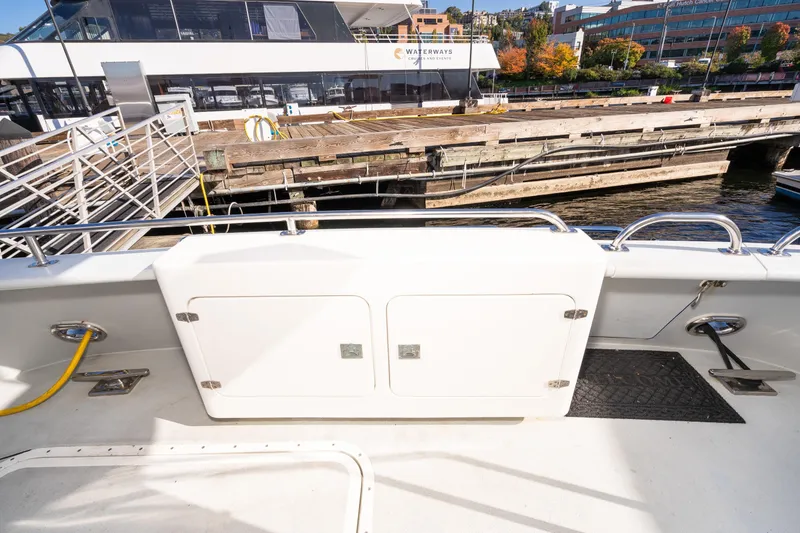 Slide: The Image of 1998 Northern Marine Trawler docked, showcasing deck and marina view. - 63