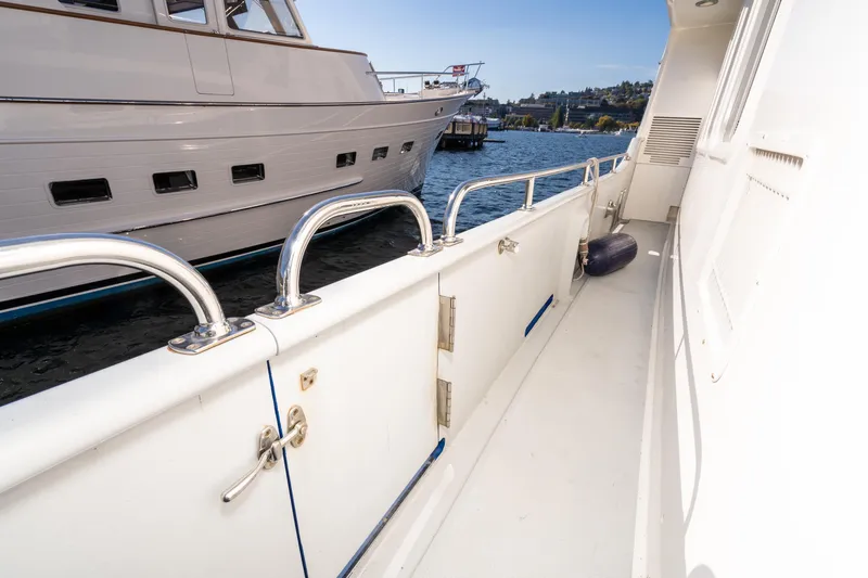 Slide: The Image of 1998 Northern Marine Trawler deck with railing, docked beside another boat. - 64