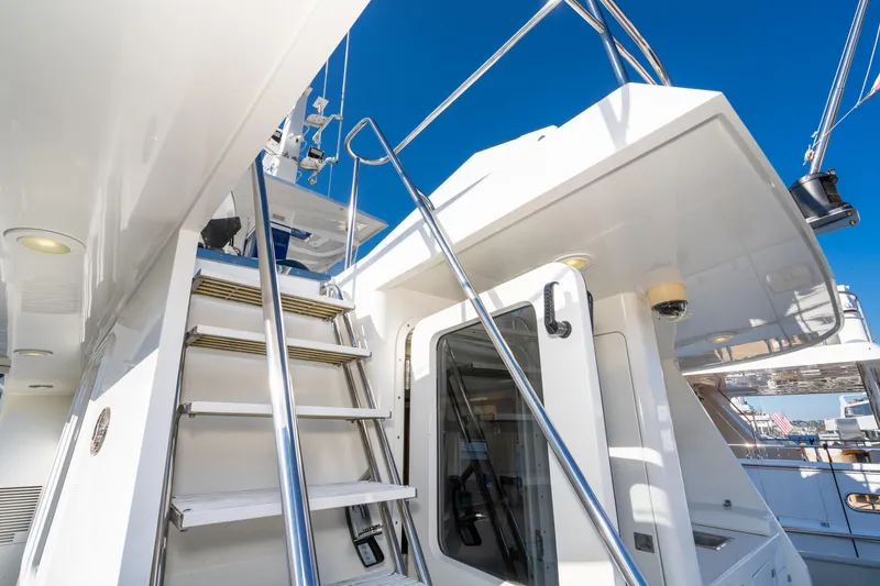 Slide: The Image of 1998 Northern Marine Trawler yacht with exterior stairs and railing under clear blue sky. - 65