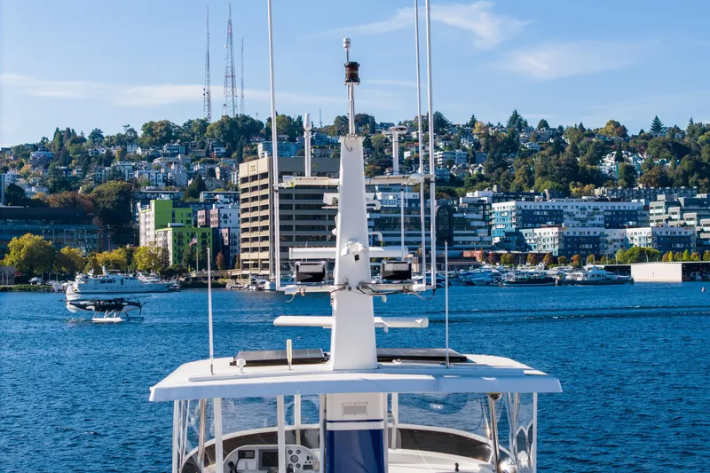 Slide: The Image of 1998 Northern Marine Trawler on blue water with cityscape and hills in the background. - 69