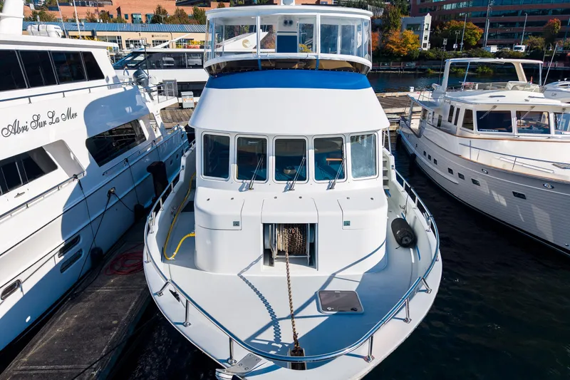 Slide: The Image of 1998 Northern Marine Trawler docked between two yachts in a marina. - 73