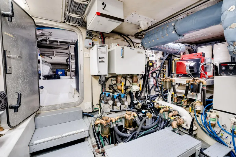 Slide: The Image of Engine room of a 1998 Northern Marine Trawler, showcasing complex machinery and equipment. - 78