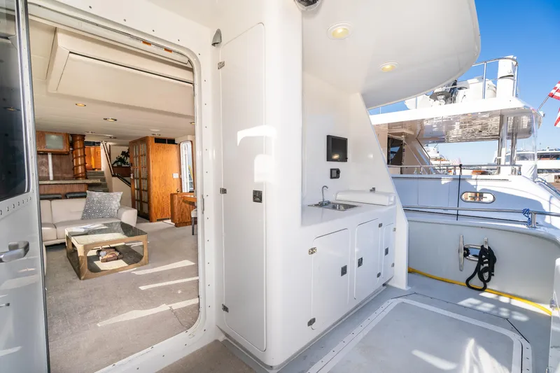 Slide: The Image of Luxurious 1998 Northern Marine Trawler interior with modern furnishings and outdoor deck view. - 8