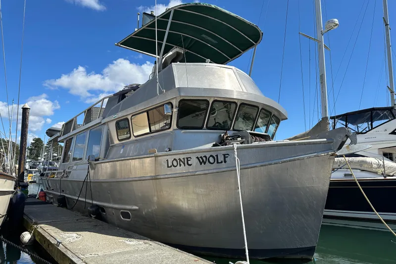 The Image of Custom 2002 Carlson Marine Trawler "Lone Wolf" docked under clear blue sky. - 0