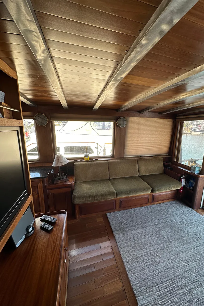 Slide: The Image of Interior of 2002 Carlson Marine Trawler with wooden decor and comfortable seating. - 10