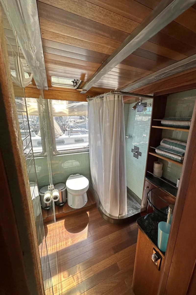 Slide: The Image of Bathroom interior of 2002 Carlson Marine Trawler with wood accents and modern amenities. - 13