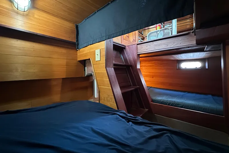 Slide: The Image of Cozy wooden cabin interior of 2002 Carlson Marine Trawler with bunk beds and ladder. - 26