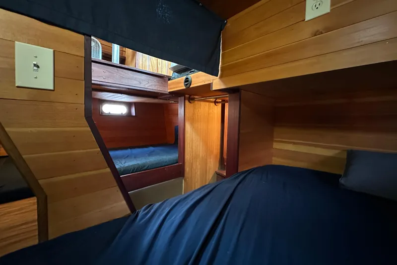 Slide: The Image of Cozy wooden cabin interior of 2002 Carlson Marine Trawler with bunk beds and soft lighting. - 27