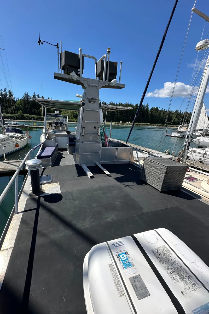 Slide: The Image of 2002 Carlson Marine Trawler on water, sunny day, docked with other boats. - 40
