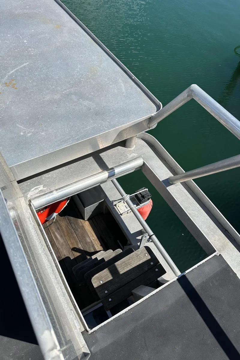 Slide: The Image of Custom Carlson Marine Trawler 2002, metal deck and railing, overlooking water. - 41