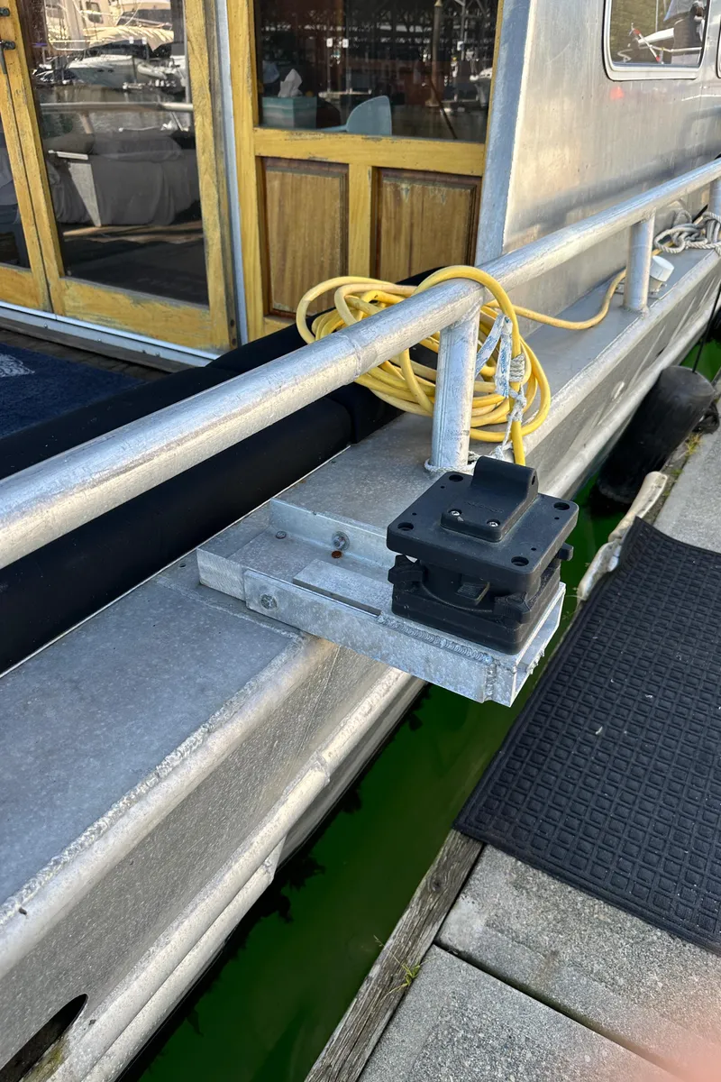 Slide: The Image of 2002 Custom Carlson Marine Trawler docked, showing railing and electrical setup. - 45